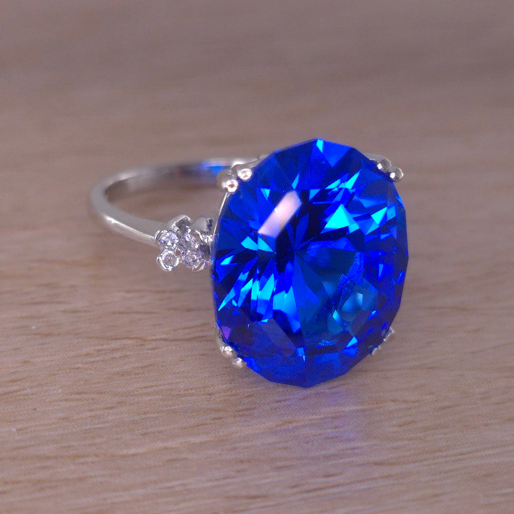 Rare Fire Blue Djeva Lab Spinel Ring with natural Garnet accent stones set in a 10k white gold