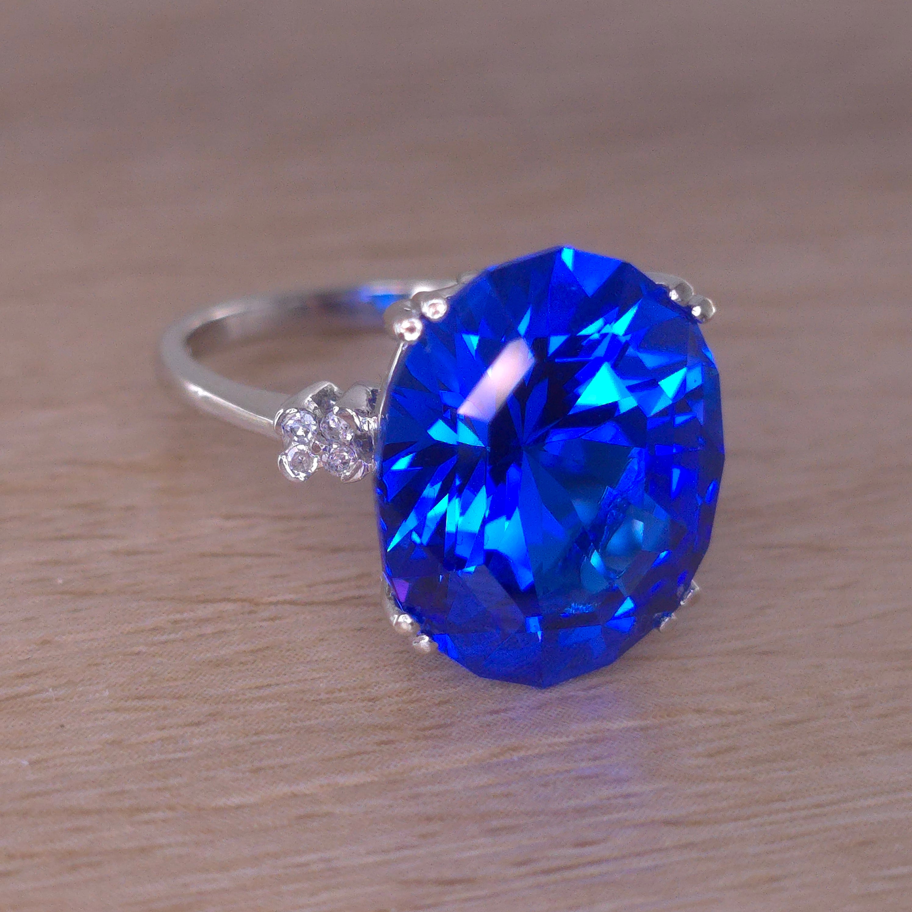 Rare Fire Blue Djeva Lab Spinel Ring with natural Garnet accent stones set in a 10k white gold
