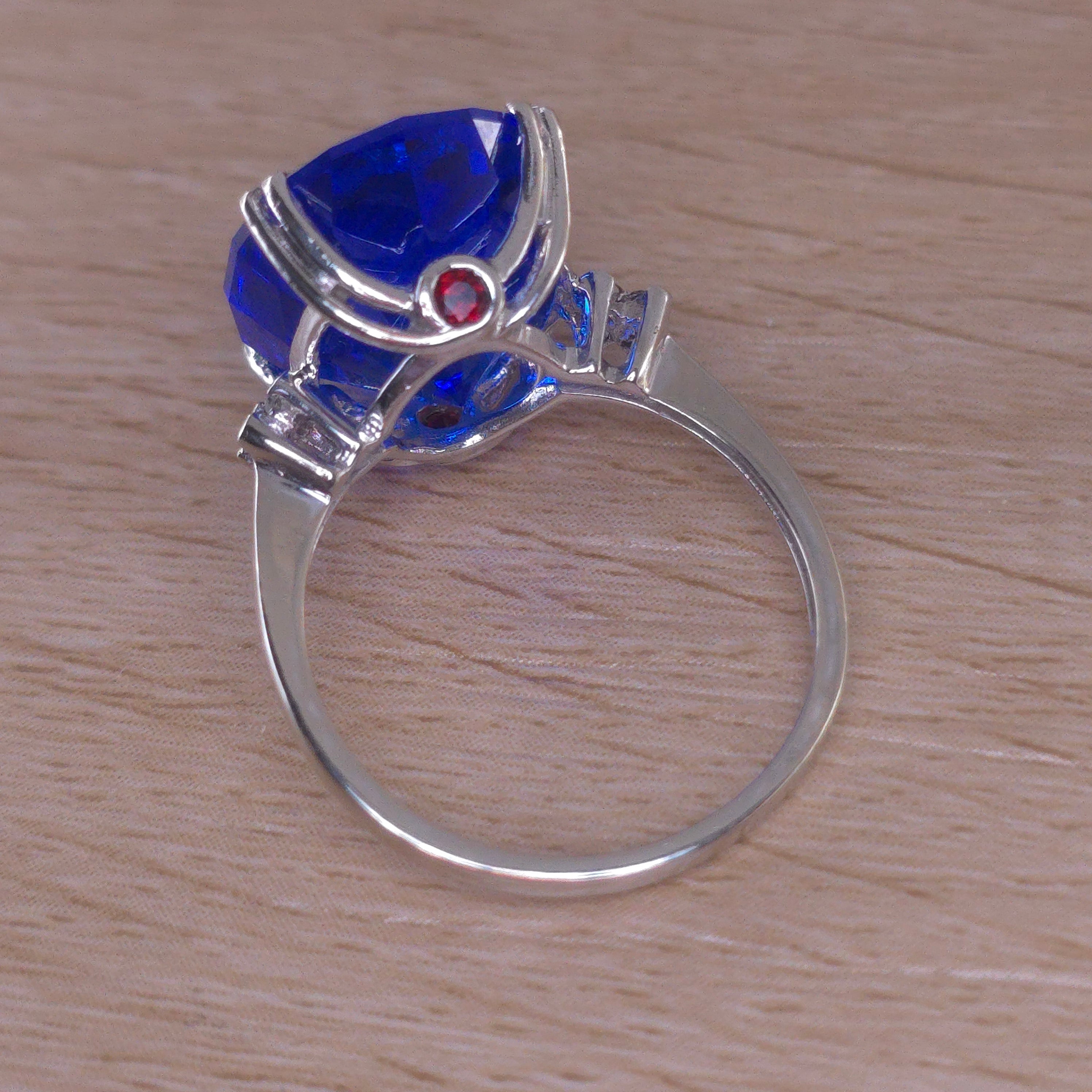 Rare Fire Blue Djeva Lab Spinel Ring with natural Garnet accent stones set in a 10k white gold