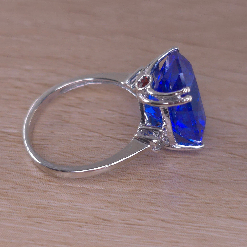 Rare Fire Blue Djeva Lab Spinel Ring with natural Garnet accent stones set in a 10k white gold