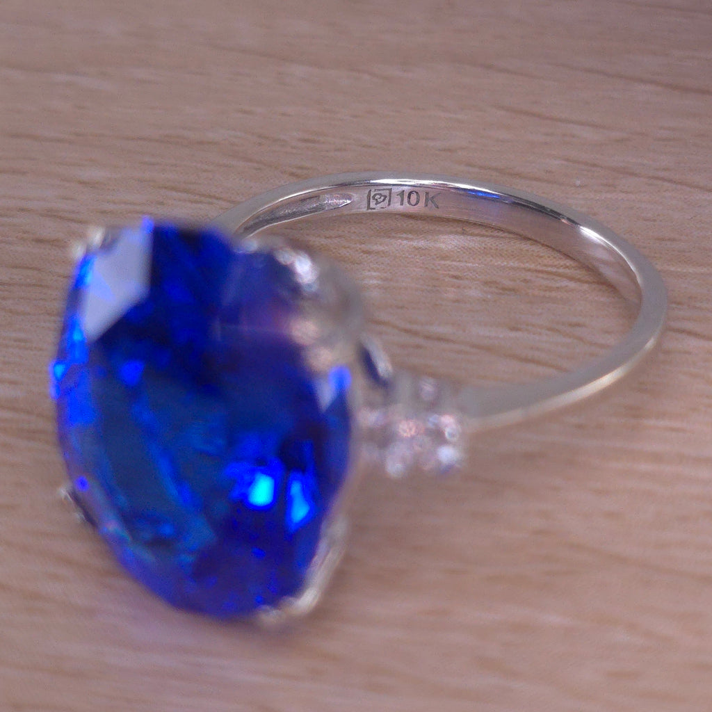 Rare Fire Blue Djeva Lab Spinel Ring with natural Garnet accent stones set in a 10k white gold