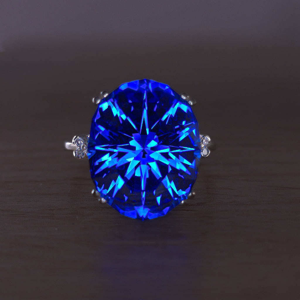 Rare Fire Blue Djeva Lab Spinel Ring with natural Garnet accent stones set in a 10k white gold