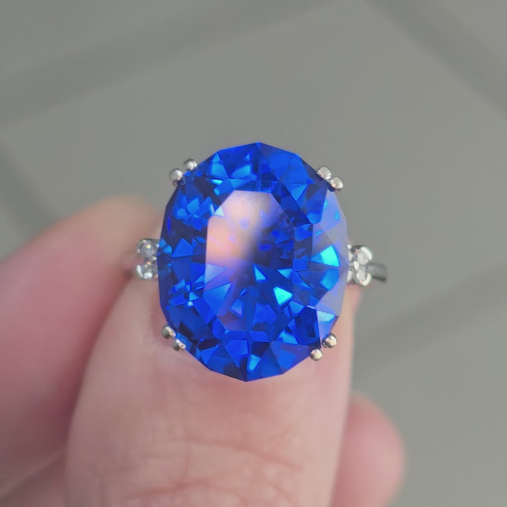 Rare Fire Blue Djeva Lab Spinel Ring with natural Garnet accent stones set in a 10k white gold